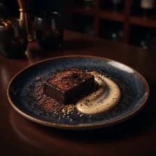 A dark chocolate square with a sweep of sesame paste and seeds