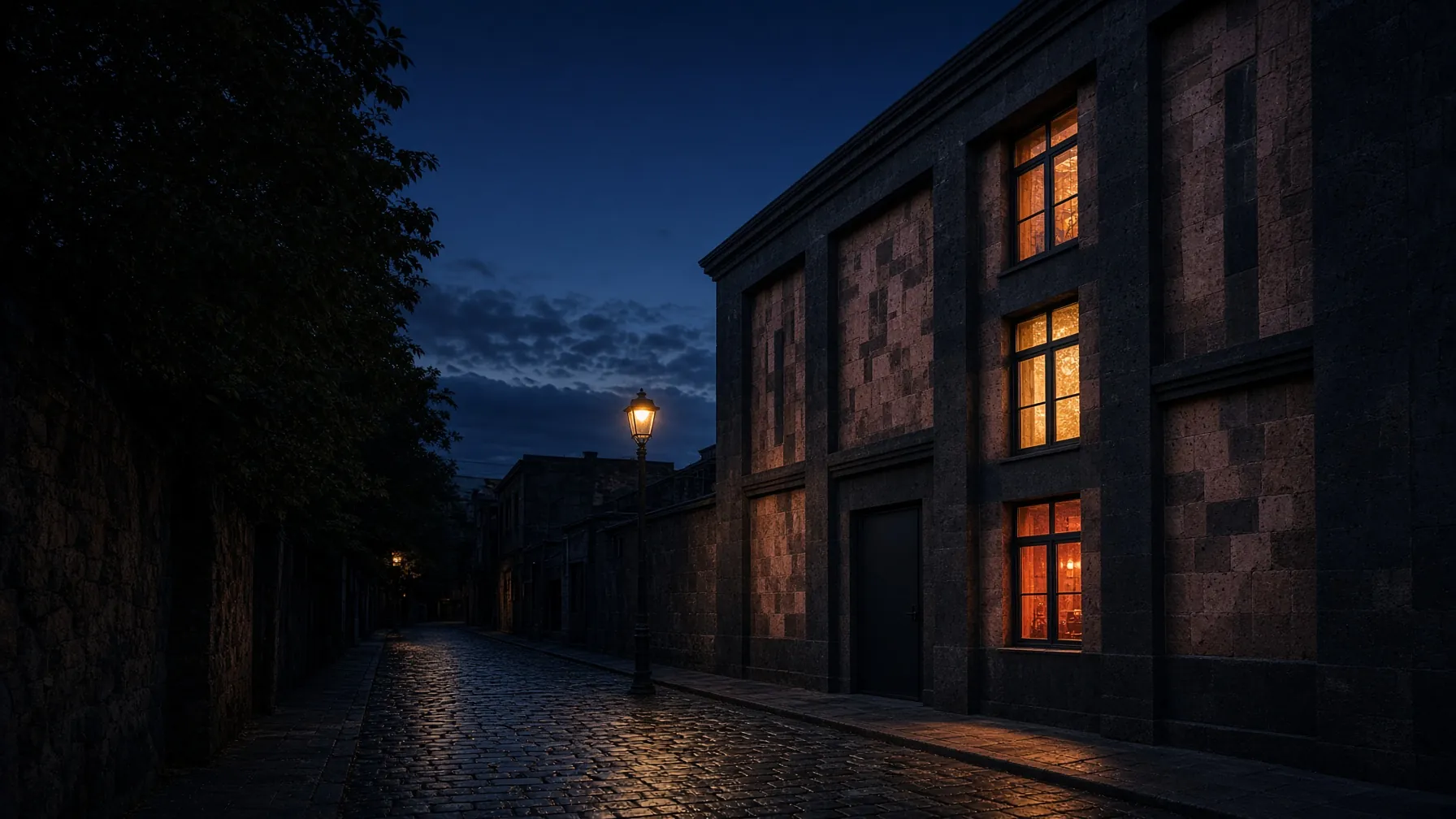 Ember at blue hour: a basalt and tufa facade on a Kentron side street, amber light in its deep-set windows.